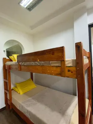 a bunk bed in a room with a yellow pillow at Peaceful Port Away From Home in Manila