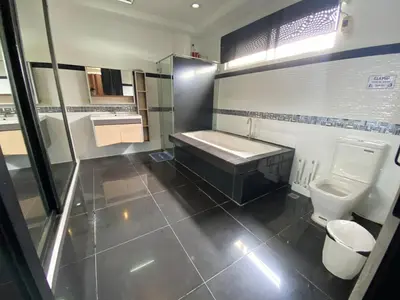a bathroom with a tub and a sink and a toilet at Peaceful Port Away From Home in Manila