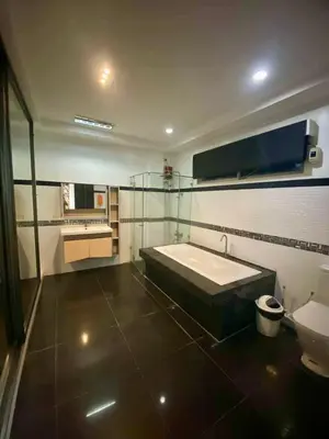 a large bathroom with a tub and a toilet at Peaceful Port Away From Home in Manila