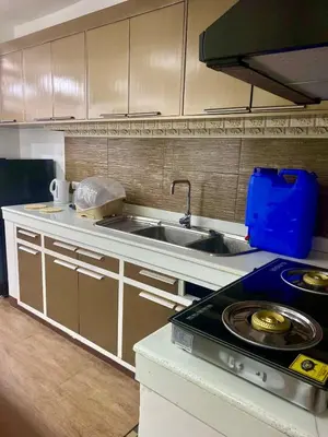 a kitchen with a sink and a stove at Peaceful Port Away From Home in Manila