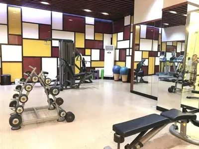 a gym with several exercise equipment in a room at Studio unit near BGC and Makati in Manila