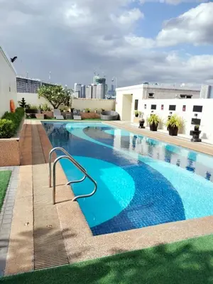 a large swimming pool on top of a building at Studio unit near BGC and Makati in Manila