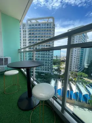 a balcony with a table and two stools at Azure Urban Resorts by Rhome in Manila