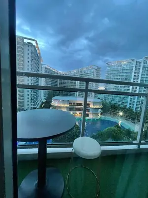 a balcony with a table and a view of a city at Azure Urban Resorts by Rhome in Manila