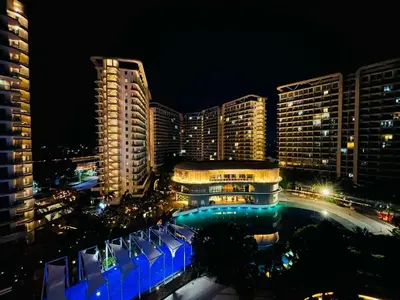 a view of a building with a pool at night at Azure Urban Resorts by Rhome in Manila
