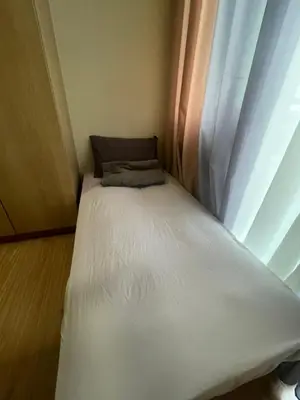 a small bed in a room with a window at Azure Urban Resorts by Rhome in Manila