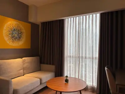 a living room with a couch and a table at Hotel Residences At Acqua in Manila