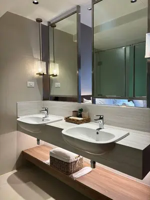 a bathroom with two sinks and a large mirror at Hotel Residences At Acqua in Manila