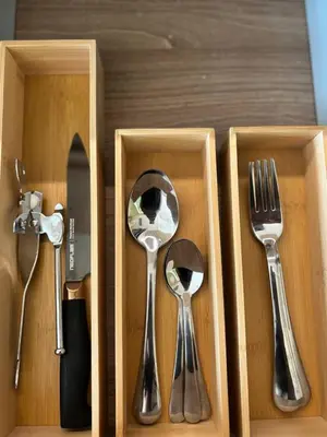 four utensils in a wooden box with forks and spoons at Hotel Residences At Acqua in Manila