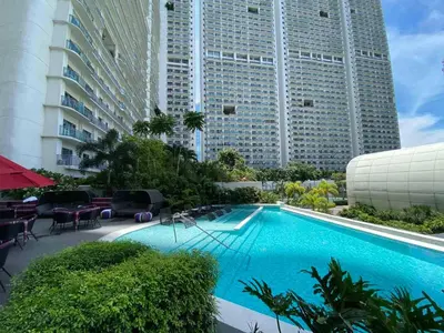 a swimming pool in front of two tall buildings at The Hotel Residences at Acqua in Manila