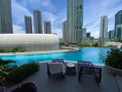 a swimming pool in a city with tall buildings at The Hotel Residences at Acqua in Manila