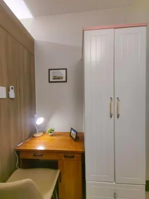 a room with a desk and a white closet at 1BR Condotel with Balcony at FAME Residences #FM37-1 in Manila