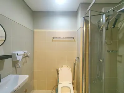 a bathroom with a shower and a toilet and a sink at 1BR Condotel with Balcony at FAME Residences #FM37-1 in Manila