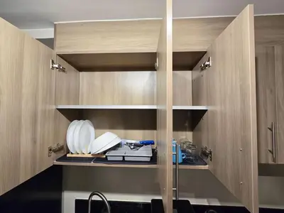 a kitchen with wooden cabinets and a sink at 1BR Condotel with Balcony at FAME Residences #FM38-1 in Manila