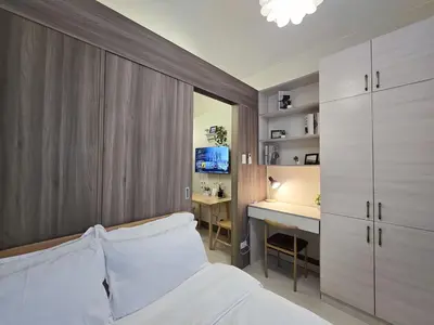 a bedroom with a bed and a desk in it at 1BR Condotel with Balcony at FAME Residences #FM39-1 in Manila