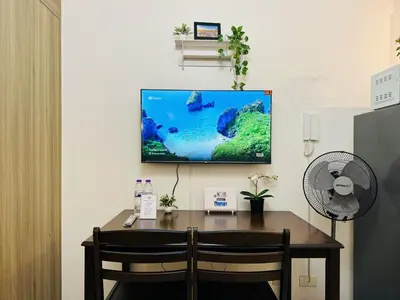 a flat screen tv hanging on a wall with a desk at 1BR Condotel with Balcony at FAME Residences #FM42-1 in Manila