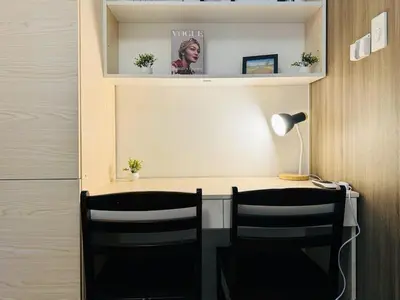 a home office with two chairs and a desk at 1BR Condotel with Balcony at FAME Residences #FM42-1 in Manila