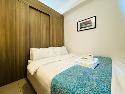 a hotel room with a bed with a roll of toilet paper on it at 1BR Condotel with Balcony at FAME Residences #FM42-1 in Manila