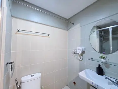 a bathroom with a toilet and a sink and a mirror at 1BR Condotel with Balcony at FAME Residences #FM43-1 in Manila