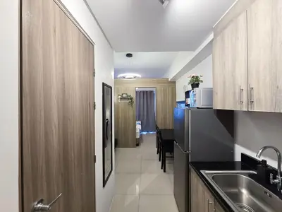 a kitchen with a sink and a refrigerator at 1BR Condotel with Balcony at FAME Residences #FM43-1 in Manila