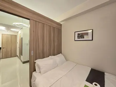 a bedroom with a white bed in a room at 1BR Condotel with Balcony at FAME Residences #FM44-1 in Manila