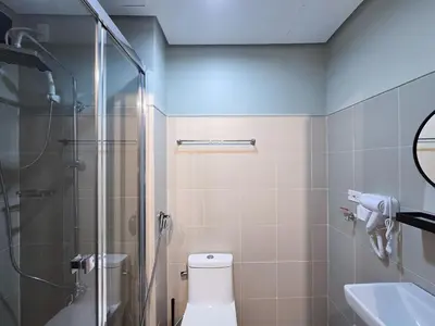 a bathroom with a shower and a toilet and a sink at 1BR Condotel with Balcony at FAME Residences #FM45-1 in Manila