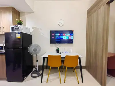 a kitchen with a table and two chairs and a refrigerator at 1BR Condotel with Balcony at FAME Residences #FM47-1 in Manila
