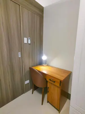 a desk with a chair and a lamp on it at 1BR Condotel with Balcony at FAME Residences #FM47-1 in Manila