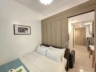 a bedroom with a bed with white pillows at 1BR Condotel with Balcony at FAME Residences #FM49-1 in Manila