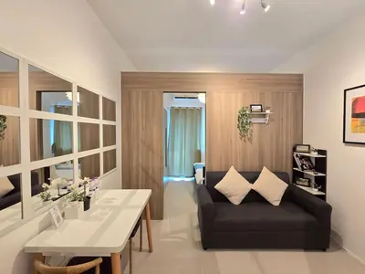 a living room with a couch and a table at 1BR Condotel with Balcony at FAME Residences #FM49-1 in Manila