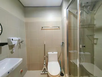 a bathroom with a shower and a toilet and a sink at 1BR Condotel with Balcony at FAME Residences #FM52-1 in Manila