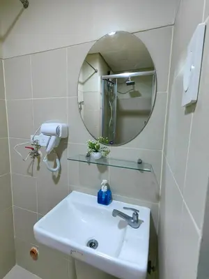 a bathroom with a sink and a mirror at 1BR Condotel with Balcony at FAME Residences #FM53-1 in Manila