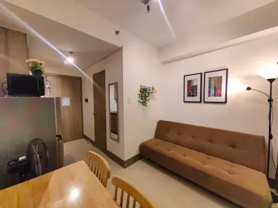 a living room with a couch and a table at 1BR Condotel with Balcony at FAME Residences #FM53-1 in Manila