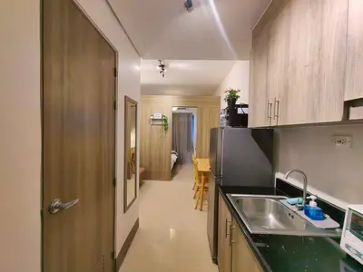a kitchen with a sink and a counter top at 1BR Condotel with Balcony at FAME Residences #FM53-1 in Manila