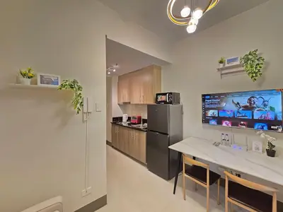 a kitchen with a counter and a refrigerator at 1BR Condotel with Balcony at FAME Residences #FM54-1 in Manila