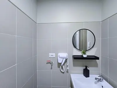 a white bathroom with a sink and a mirror at 1BR Condotel with Balcony at FAME Residences #FM57-1 in Manila