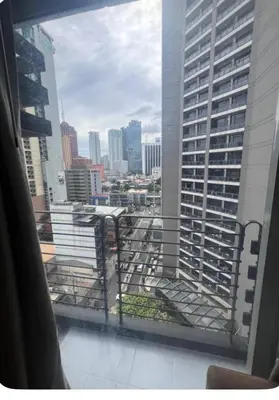 a view of a city skyline from a window at Poblacion Makati Condo in Manila