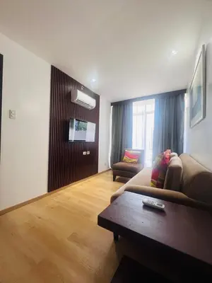 a living room with a couch and a coffee table at Poblacion Makati Condo in Manila