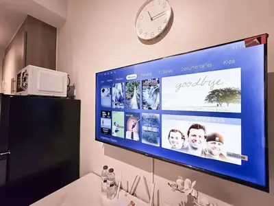 a large flat screen tv hanging on a wall at 1BR Condotel with Balcony at FAME Residences #FM59-1 in Manila