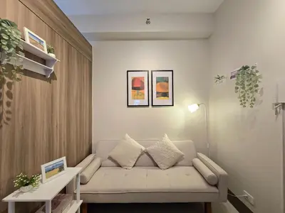 a living room with a couch and a table at 1BR Condotel with Balcony at FAME Residences #FM59-1 in Manila