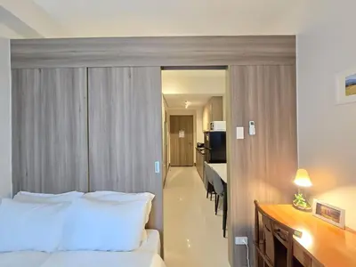 a hotel room with a bed and a desk at 1BR Condotel with Balcony at FAME Residences #FM59-1 in Manila