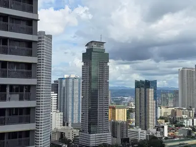 a tall building in a city with tall buildings at 1BR Condotel with Balcony at FAME Residences #FM60-1 in Manila