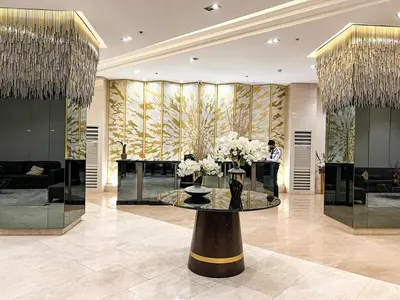 a lobby with a table with flowers on it at 1BR Condotel with Balcony at FAME Residences #FM60-1 in Manila