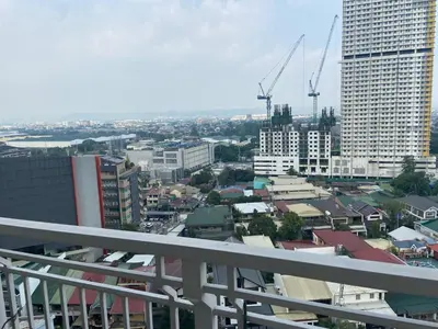 a view of a city with buildings and cranes at Lumiere Residences in Manila