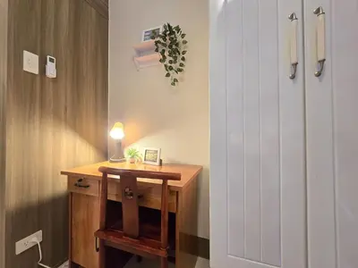 a room with a desk and a white door at 1BR Condotel with Balcony at FAME Residences #FM61-1 in Manila