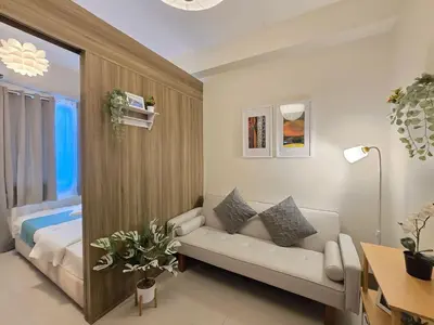 a living room with a couch and a bed at 1BR Condotel with Balcony at FAME Residences #FM64-1 in Manila
