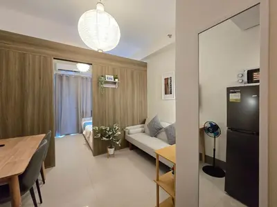 a living room with a couch and a table at 1BR Condotel with Balcony at FAME Residences #FM64-1 in Manila