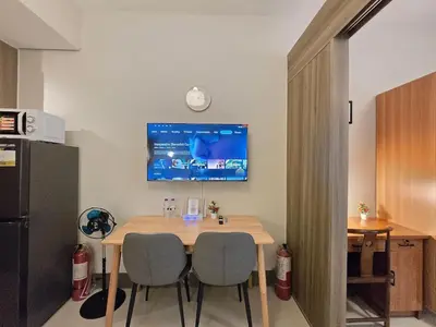a kitchen with a table and two chairs and a refrigerator at 1BR Condotel with Balcony at FAME Residences #FM64-1 in Manila