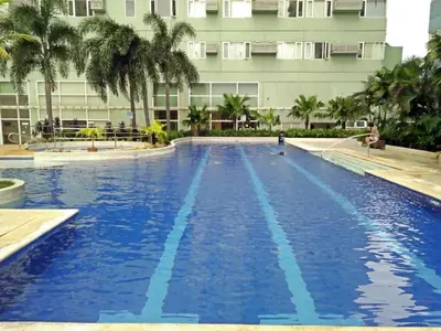 a large swimming pool in front of a building at 1BR Condotel Ridgewood Towers Near Airport #RW01-1 in Manila