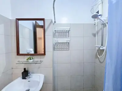 a white bathroom with a sink and a mirror at 1BR Condotel Ridgewood Towers Near Airport #RW02-1 in Manila